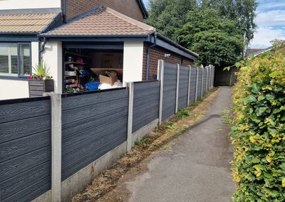Grey composite fencing installed beside a house