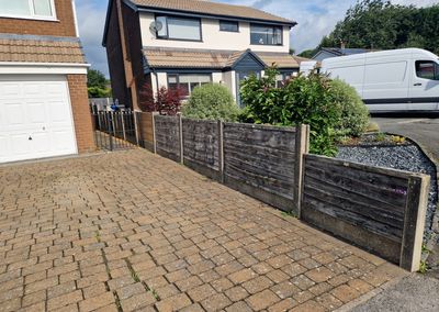 Grey composite fencing installed beside a house