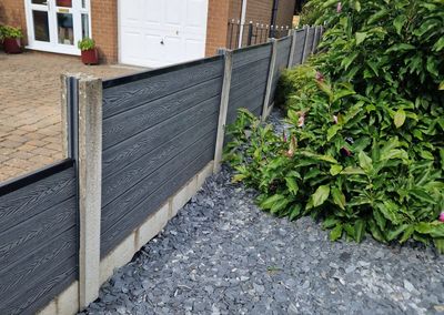 Grey composite fencing installed beside a house