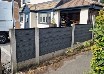 Grey composite fencing installed beside a house