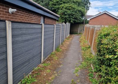 Grey composite fencing installed beside a house
