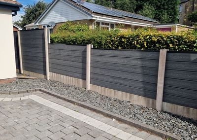 Grey composite fencing installed beside a house