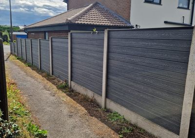 Grey composite fencing installed beside a house