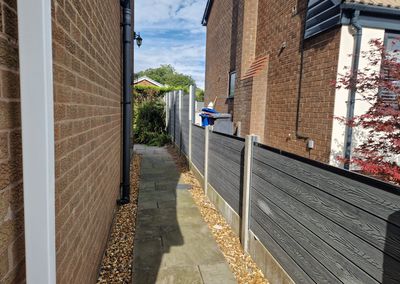 Grey composite fencing installed beside a house