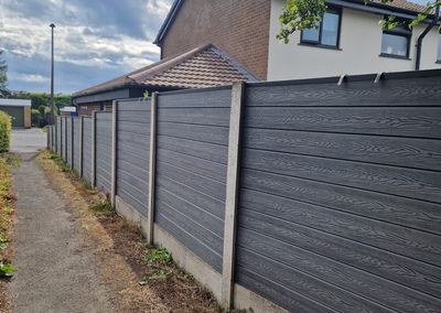 Grey composite fencing installed beside a house