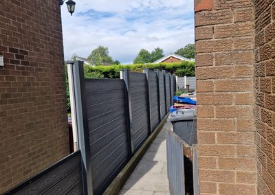 Grey composite fencing installed beside a house