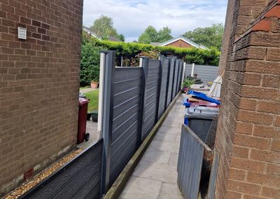 Grey composite fencing installed beside a house