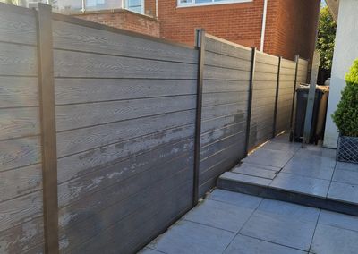 Grey composite fencing around a garden and patio