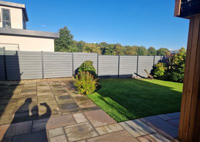 Grey composite fencing around a garden and patio
