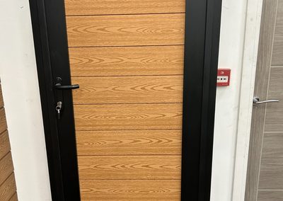 Oak effect composite pedestrian gate with black frame
